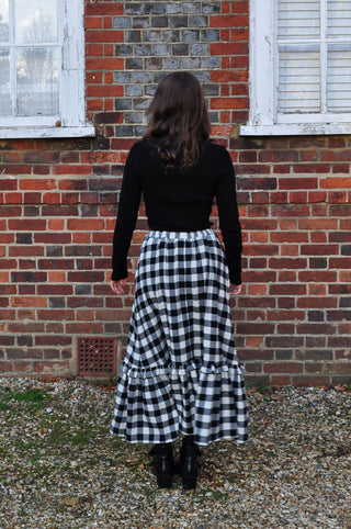 woman wearing gingham skirt back