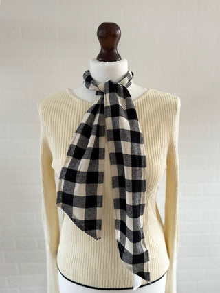 black tartan scarf on mannequin