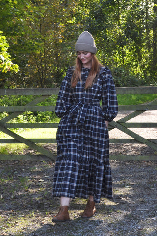 woman stood by gate wearing dress