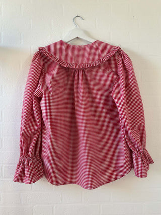 gingham blouse on hanger
