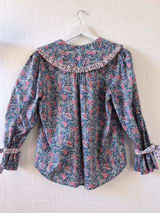 mixed floral blouse on hanger back