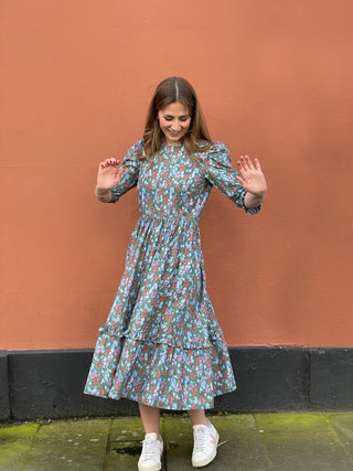 women wearing cotton floral dress by wall