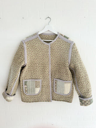 quilted jacket hanging on wall front