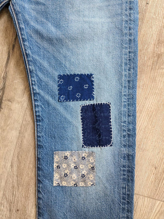 patched upcycled levi jeans on floor