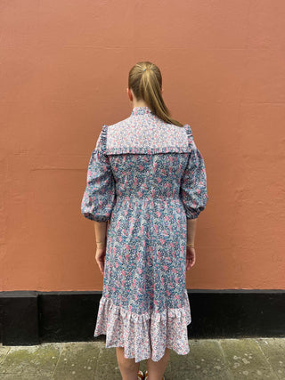 women wearing mixed print floral dress back view
