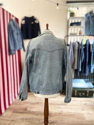 mended denim jacket on mannequin back