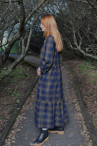 woman on walk wearing check dress side view