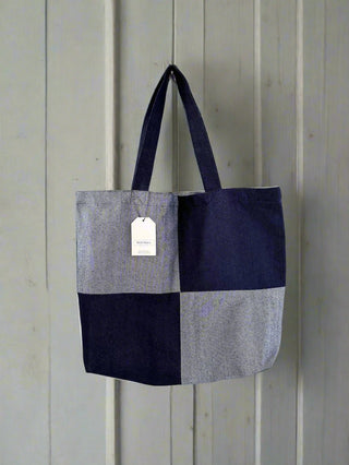 denim bag on wooden wall