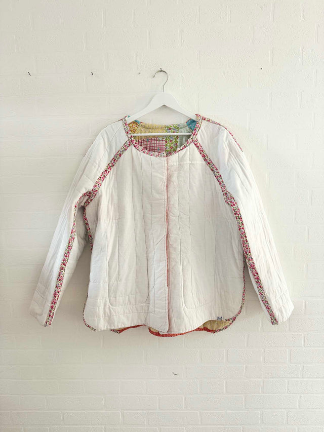 The Well Worn white quilted jacket in studio
