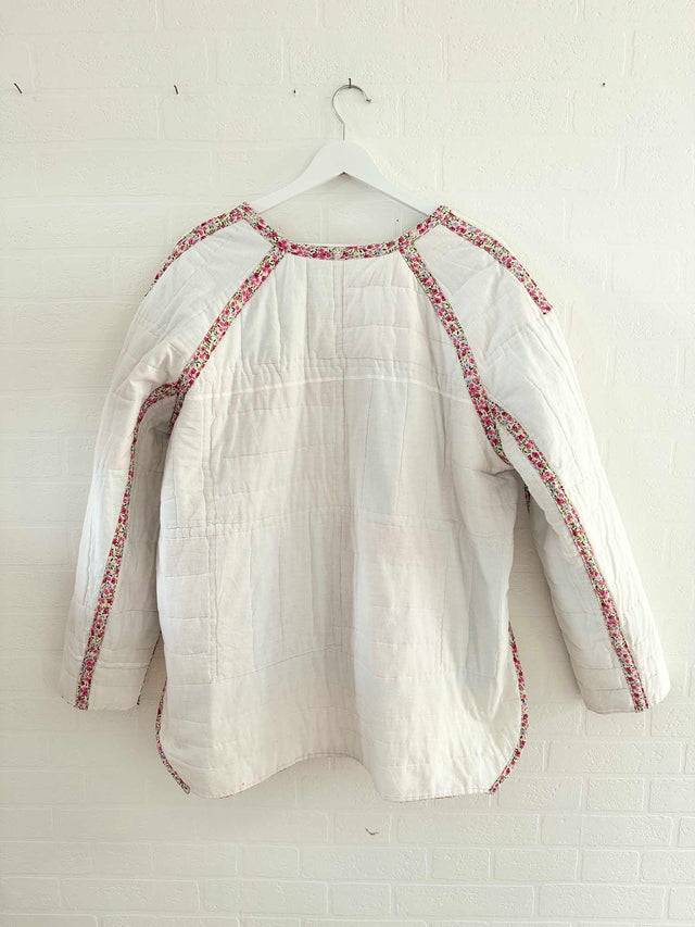 The Well Worn back of white quilted jacket on wall