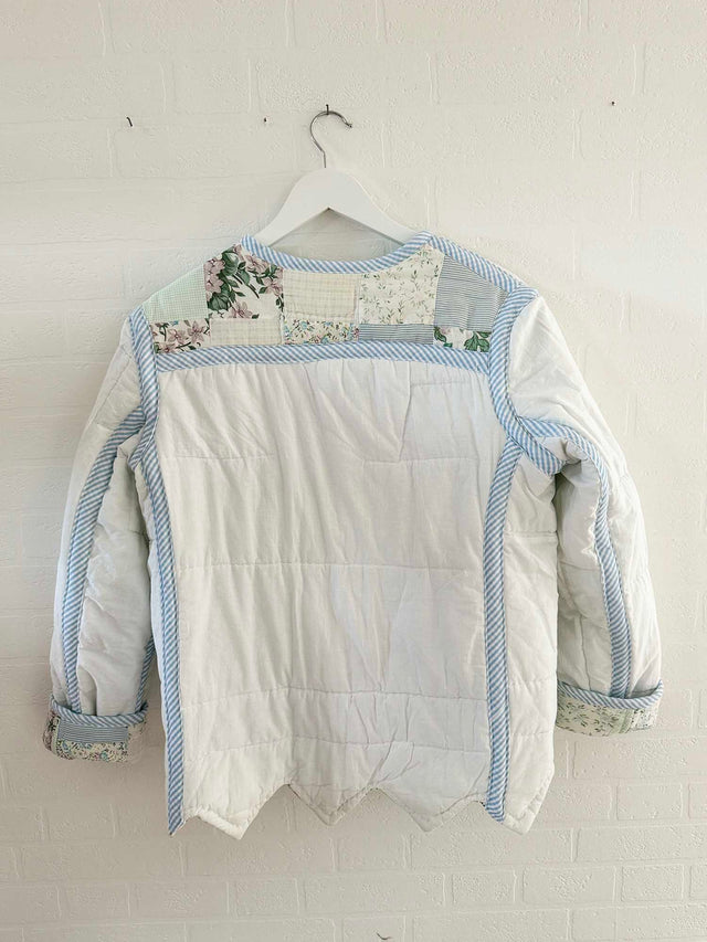 The Well Worn vintage quilted jacket hung wall back detail