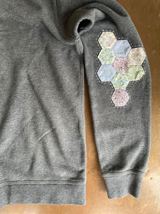 upcycled sweatshirt on table patchwork