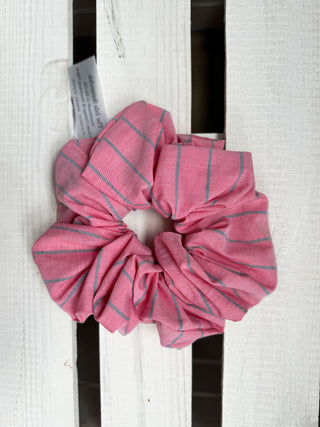 soft pink stripe scrunchie on wooden table