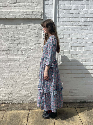 women wearing blue floral print midi dress side view
