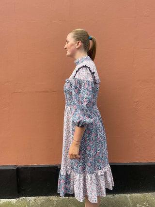 women wearing mixed print floral dress side view
