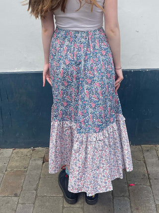 women wearing mixed print skirt back view