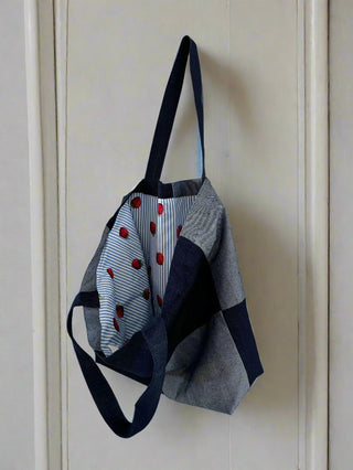 denim bag on wooden wall