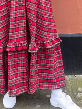 women wearing tartan dress skirt detail
