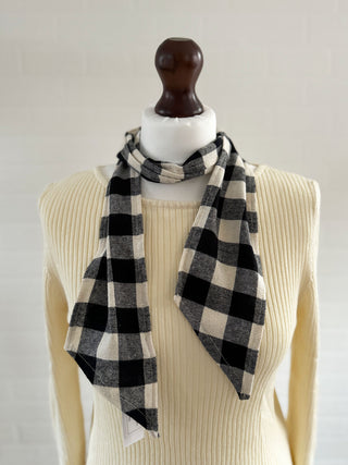 black and white tartan scarf on mannequin