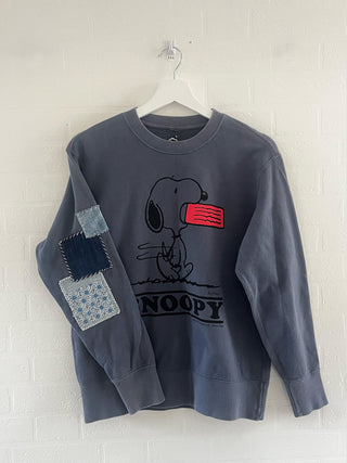 upcycled snoopy sweatshirt on hanger