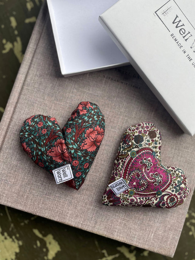 The Well Worn hearts on table with box